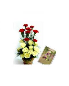 An arrangement of 12 yellow roses along with 8 red carnations along with a message card.